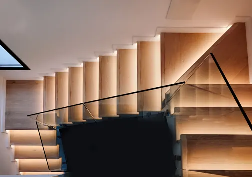 Modern duplex staircase interior design with railings and lighting